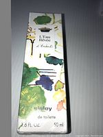 Front view of box showing Sisley L'Eau Révée d'Isabet Eau de Toilette 50 ml with colorful botanical artwork and text.