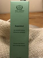 Front of the light green box showing Tata Harper logo, product name Superkind Bio-Barrier Serum with intensive age defense claims.