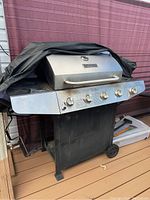 Full view of Master Forge 54 inch BBQ grill showing the stainless steel body, side burner on right, control knobs, and wheels.
