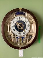 Front view of entire clock showing frame, dial, interior features