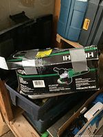 Hitachi 4-1/2 inch disc grinder box taped closed, showing model and specifications.