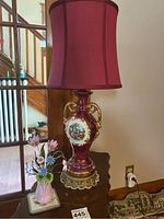 Victorian style glass vase lamp with burgundy glass vase body, gold handles and trim, metal base, red lampshade