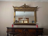 Front view of the rectangular mirror hung on wall above wooden console.
