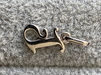 Front view of the white gold squirrel pendant showing the design and bail