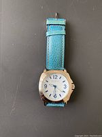 Front view of Joan Rivers Classics watch with blue leather band showing dial and watch face.