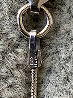 Close-up of pendant bail stamp showing 925 Italy mark, confirming sterling silver material.