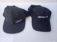 Both hats displayed side by side, showing logos and overall condition.