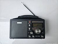 Front view of black Eton Grundig S350DL shortwave radio with display showing 137, speaker on left, tuning and volume knobs on right.