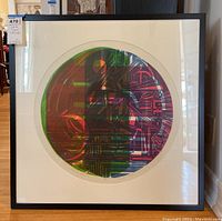 Front view of framed circular lithograph titled "Planet Storm." Shows colors and signature with numbering visible along bottom edge.