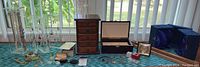 Overview of two acrylic racks, four jewelry boxes and loose jewelry pieces on table