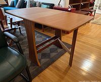 Table with both leaves extended, showing full surface and support.