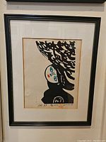 Framed abstract art print showing the full artwork and frame including visible artist proof markings below image.