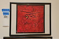 Full frontal view of framed print showing red-and-black abstract image, white mat, black frame, and size tag