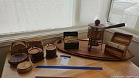 Overview showing copper fondue pot, wood tray, two wooden recipe boxes, and multiple coaster sets in varied materials and designs.