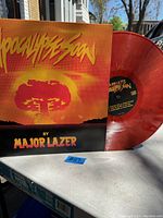 Red marbled vinyl LP Apocalypse Soon by Major Lazer displayed with sleeve