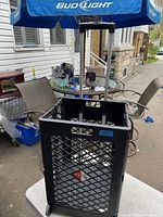 Pack & Roll folding cart fully unfolded showing open rectangular base, lattice sidewalls, and extended telescoping handle.