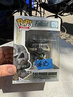 Photo of a hand holding original boxed Funko Pop Games Fallout T-51 Power Armor figure number 370.