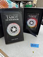 The Wild Unknown Tarot deck and guidebook in black box with colorful circular artwork.