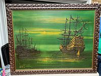 Full view of the vintage framed print showing two sailing ships at sunset in a green background with carved wood frame.