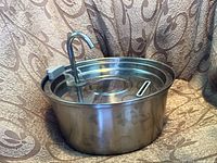 Stainless steel cat water fountain assembled, showing the spout and water basin.