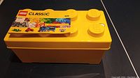 Yellow LEGO Classic storage box with lid shaped like LEGO studs
