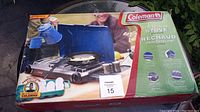 Original retail box featuring the Coleman 2-burner propane stove, showing model usage and brand name.