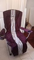 Front view of the large folding camping chair in burgundy and gray stripe upright position.