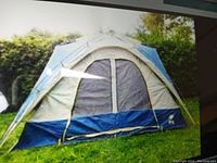 Full view of pitched Northern Escape camping tent with large mesh door and ventilation panels, showing blue, grey, and tan fabric and tent frame poles.