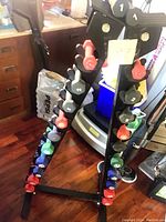 Black A-frame metal weight stand with 22 colorful hex dumbbells arranged on four tiers
