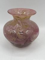 Front view of pink antique glass vase with gold swirling patterns showing rounded body and flared rim.