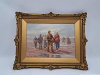 Front view of painting in gilt wood frame showing group of figures on beach
