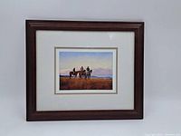 Frontal view of framed print showing the full artwork with three cowboys on horses and mountain landscape.