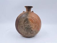 Front view showing decorative figure and round body