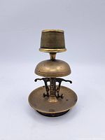 Full view of unique vintage brass bell, showing overall condition and shape