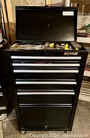 Open Waterloo tool tower with top lid open showing assorted tools in top tray