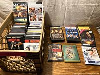 Three crates filled with DVDs including popular movies and various genres.