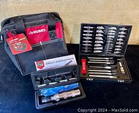 Overall lot showing Husky canvas tool bag, SureBilt impact screwdriver set with case, and Pro Series modelling knife set open showing tools and blades.
