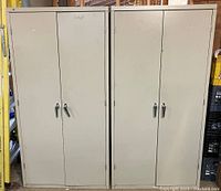 Front view of two closed putty-colored steel cabinets side by side