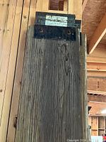 Close-up of one wood plank ramp showing the steel topping fixed with bolts and the wood's grain and knots