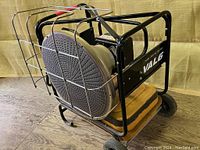 Front-left angle view showing entire heater unit on dolly base with wheels