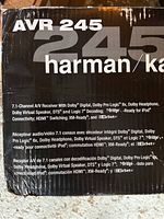 Box front displaying model number AVR 245 and Harman Kardon branding with multilingual feature descriptions.