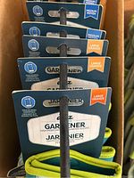 Multiple pairs of Digz branded gardening gloves in a box, showing touchscreen compatibility and size labels medium and large.