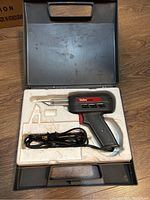 Weller 8200 soldering gun in molded foam inside black plastic carrying case from overhead.