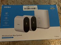 Box of AOSU WirelessCam Max System showing two cameras and base station graphic, highlighting secure local storage.