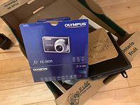 Olympus FE-5020 camera box, blue with photo of camera and text, showing model and features.