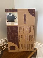 Photo showing front side of original unopened Sauder File Cart box with product details and image of the file cart.