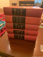 Stack of five red hardcover Winston Churchill books titled on spine with black bands and gold lettering.