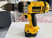 Side view of DeWalt cordless drill showing adjustable torque settings and battery base.