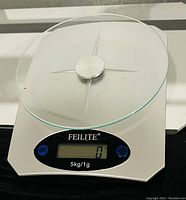 Photo of Feilite digital kitchen food scale with glass surface, buttons, and display.