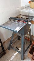 Full view of the Craftsman electric table saw on metal stand in a workshop environment.